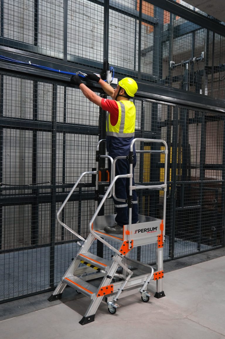 Operario sobre plataforma industrial EPN instalando un cableado